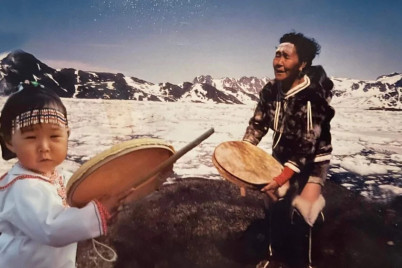 Anna Kûitse Thastum and her grandddaughter playing the Inuit frame drum qilaat. Photographer unknow